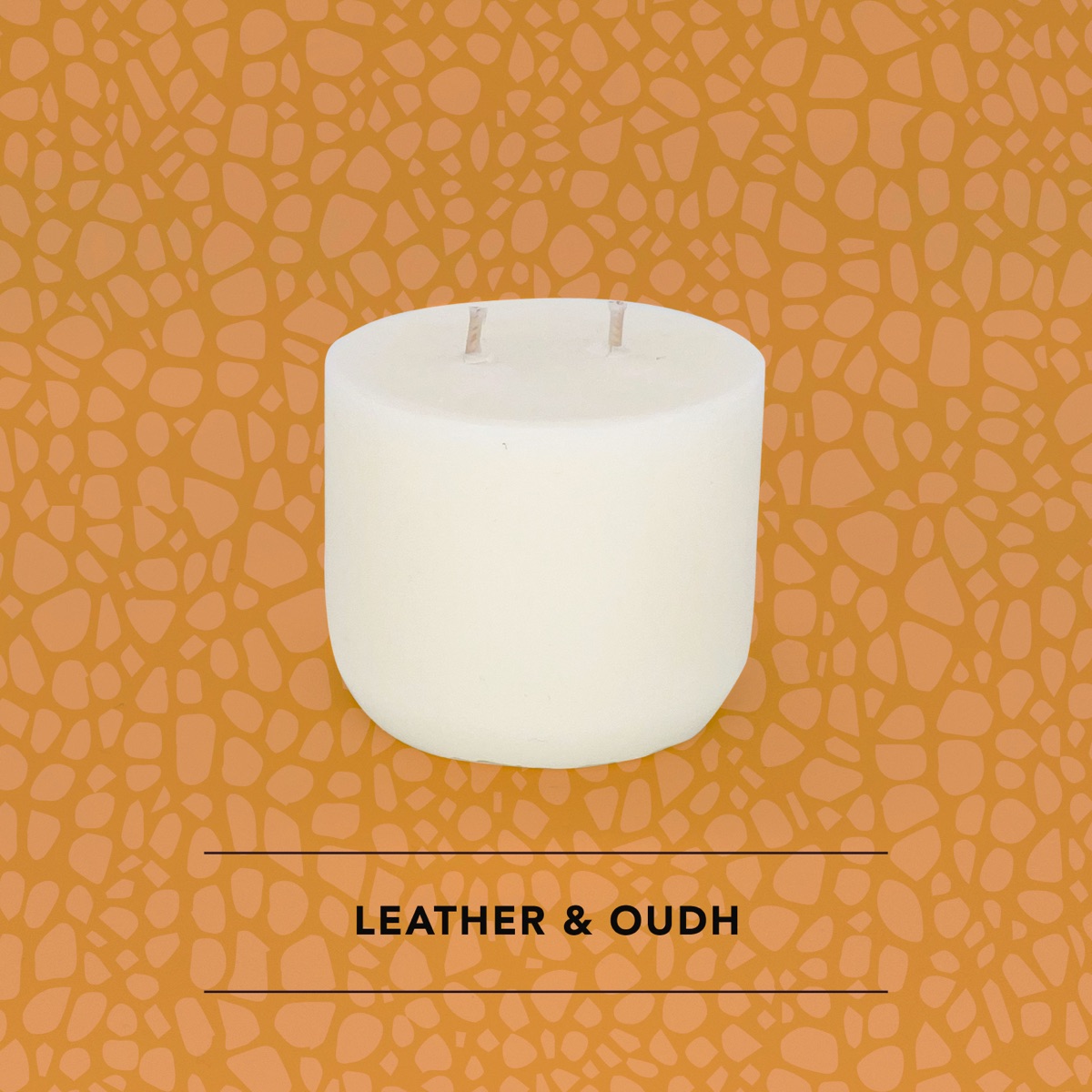 Honey Willow Leather and Oudh soy candle in a white vessel against a tan leather-textured background